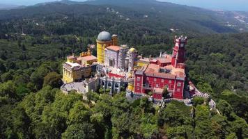 Aerial drone view of Park and National Palace of Pena in Sintra, Portugal during a sunny day. Unesco World Heritage. Historic visits. Holidays and summer vacation tourism. Colorful palace. video