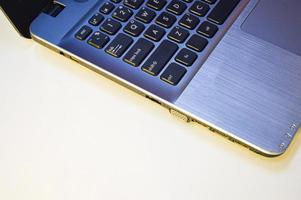 side view left side of laptop on a white background and using yellow-orange light photo