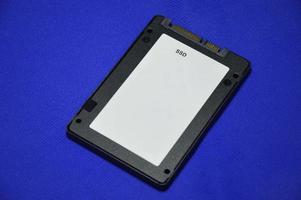 2.5 inch SSD hard drive laid on a blue background. photo