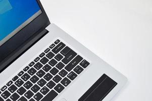 top right view of a white laptop on a white background photo