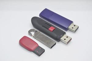Flash drives, many shapes, old condition, placed on a white background. photo