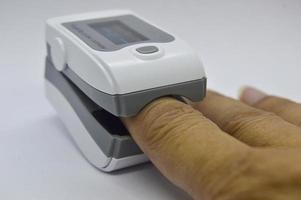 Image while using the blood oxygen monitor and heart rate monitor, the device that should be attached. in the treatment of covid 19 photo