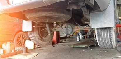 rear of pickup truck that was lifted off the ground to prepare for repair photo