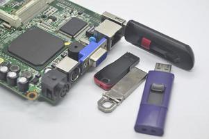 Flash drives, many shapes, old condition, placed on a white background and Plug into the motherboard, into the USB connector. photo