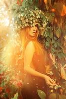 delightful lady with a wreath of hops in the magic forest photo