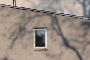 part old building with windows in the morning sun with shadow photo