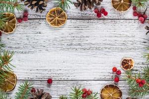 Christmas branches with cones viburnum berries and dry lemon slice photo