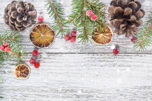 Christmas branches with cones viburnum berries and dry lemon slice photo