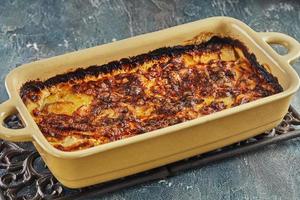 Potato and sweet potato gratin with Provence herbs is baked in the oven. French gourmet cuisine photo