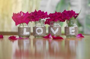 Love on the bottle with rose for Valentine's day or wedding background photo