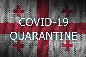 Georgia flag and Covid-19 quarantine inscription. Coronavirus or 2019-nCov virus photo