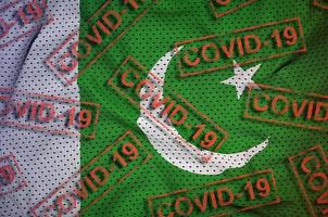 Pakistan flag and many red Covid-19 stamps. Coronavirus or 2019-nCov virus concept photo