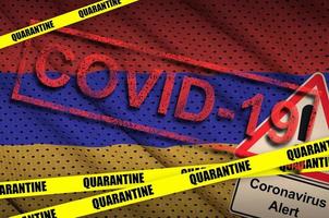 Armenia flag and Covid-19 quarantine yellow tape with red stamp. Coronavirus or 2019-nCov virus photo