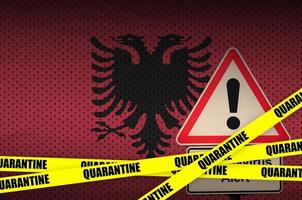 Albania flag and Covid-19 quarantine yellow tape. Coronavirus or 2019-nCov virus photo