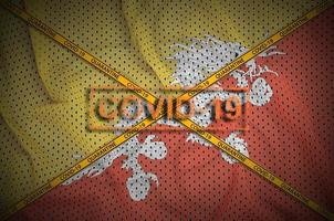 Bhutan flag and Covid-19 stamp with orange quarantine border tape cross. Coronavirus or 2019-nCov virus concept photo