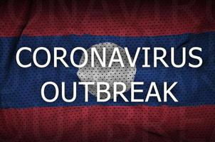 Laos flag and Coronavirus outbreak inscription. Covid-19 or 2019-nCov virus photo