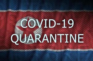 North Korea flag and Covid-19 quarantine inscription. Coronavirus or 2019-nCov virus photo