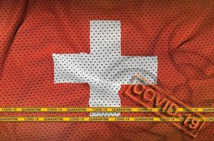 Switzerland flag and orange Covid-19 stamp with border tape. Coronavirus or 2019-nCov virus concept photo