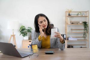 Young asian woman calculating expenses household about finance and frustrated on desk at home, girl checking bill having stress and worried, debt and tax, expression and emotion, business concept. photo