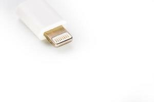 Connector lightning on a white background. This is a proprietary connector used to connect mobile devices to well-known host computers photo