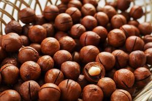 Texture of organic macadamia nut fresh natural fruit shelled one nut in full frame close-up view photo