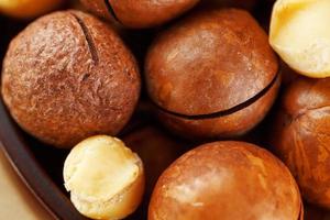 Macadamia nut on wooden background with vintage cloth, concept of superfoods and healthy food photo