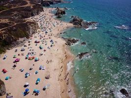 Aerial drone view of busy Beach in Algarve, Portugal during summer holidays. Amazing destinations.  Travel and adventure. Vacations on the seaside.  Exotic traveling. Most visited places. photo