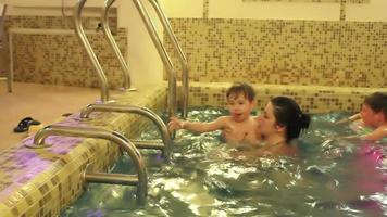 Family having fun in indoor pool video