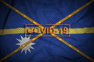 Nauru flag and Covid-19 stamp with orange quarantine border tape cross. Coronavirus or 2019-nCov virus concept photo