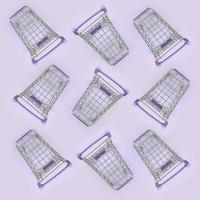 Pattern of many small shopping carts on a violet background. Minimalism flat lay top view photo