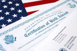 Fs-545 Certification of birth abroad lies on United States flag with envelope from Department of Homeland Security photo