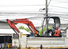 Image of moving the excavator using a truck photo