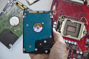 Hard disk drives are still widely used. hard drive in hand photo