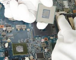 image of a mechanic repairing computer motherboard, electronic motherboard repair photo