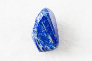 tumbled Lapis Lazuli Lazurite rock on white photo