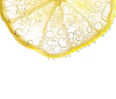 Juicy lime slices with bubbles under water isolated on white background. Yellow lemon slices pattern textured background. photo