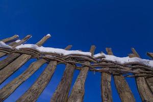 Wooden fence with snow photo