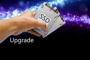 SSD hard drive, hand holding SSD photo