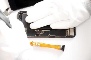 top view, technician fixing a smartphone photo