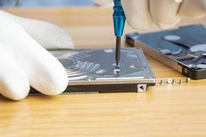 mechanic repairing hard drive, hard drive It is a device for storing data. photo