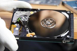 mechanic repairing hard drive, hard drive It is a device for storing data. photo