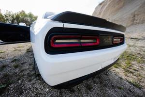 Back lights of white powerfull american muscle car in career. photo