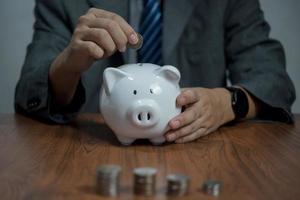 Man hand holding piggy bank, saving money wealth and financial concept, Business, finance, investment, Financial planning. photo