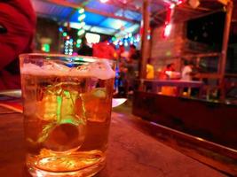 Defocus blurred cold glass of beer in a bar. photo