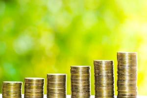 Business Finance and Money concept, Money coin stack growing graph with green tree bokeh background,investment concept photo