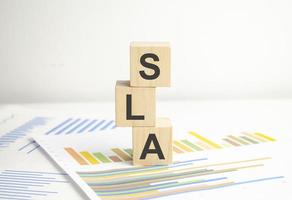 Above are three wooden blocks with the words SLA Service Level Agreement photo