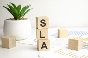 Above are three wooden blocks with the words SLA Service Level Agreement photo