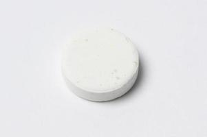 Close-up white medicine pills on white background photo