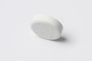 Close-up white medicine pills on white background photo