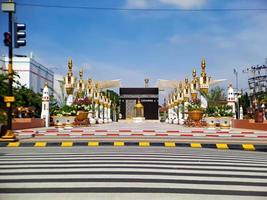 Replica of the Mecca Kaaba in the city of Madiun, East Java, Indonesia, with a beautiful clear blue sky. photo